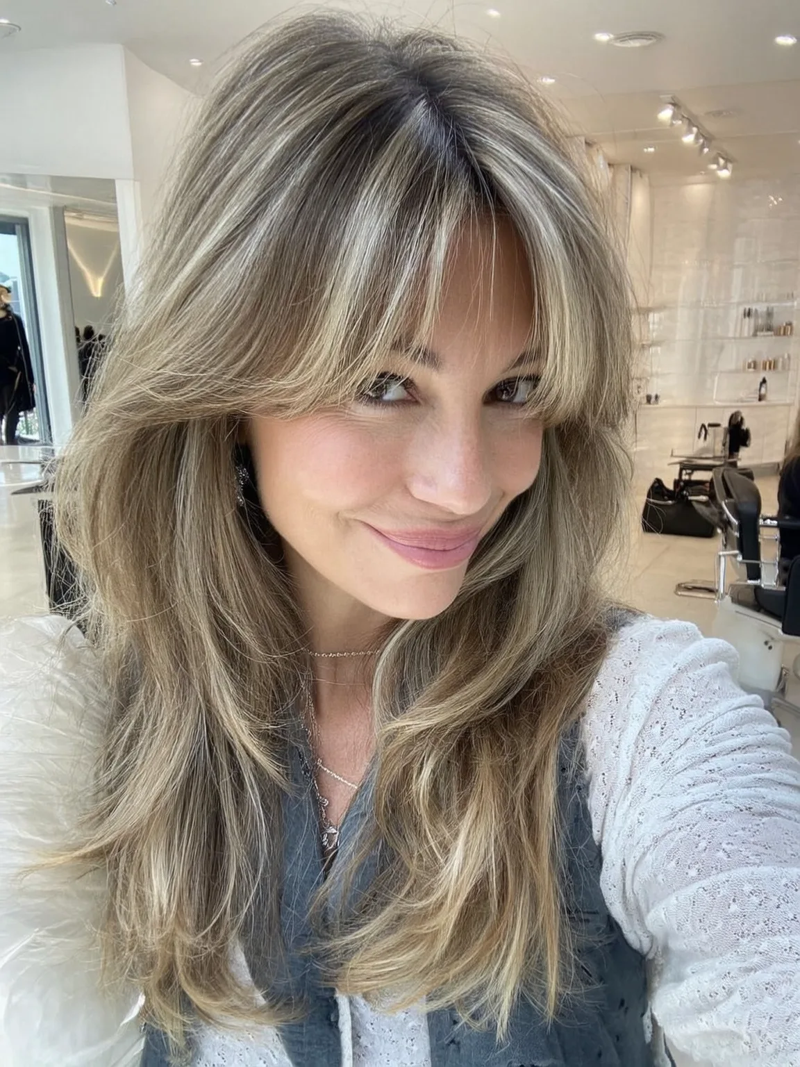 Long Voluminous Sandy Blonde Layers with Heart-Shaped Face Bangs